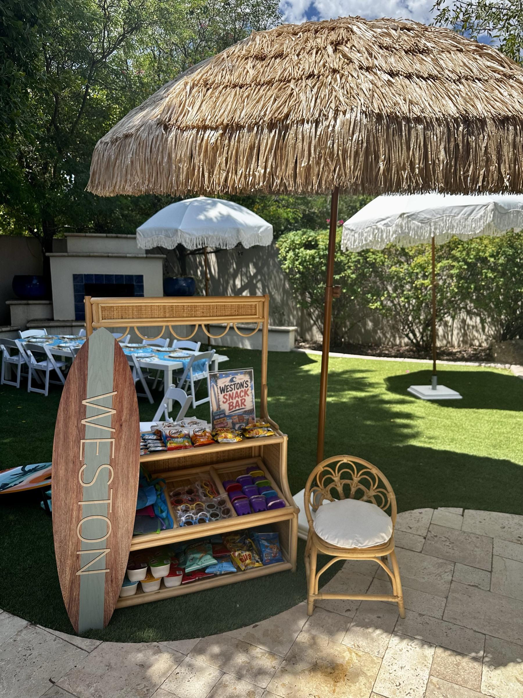 Party under a fringe umbrella with rattan chairs